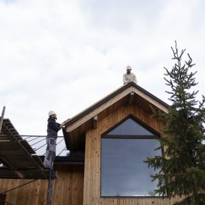long-shot-men-working-together-roof